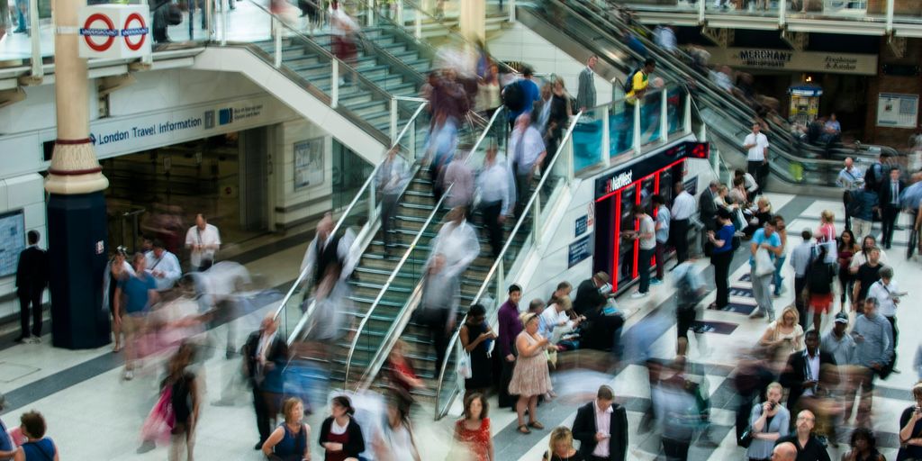 people standing and walking on stairs in mall