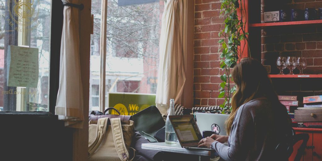 woman using computer sitting on black chair