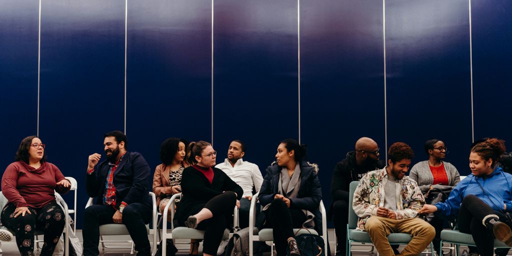 group of people sitting on chair