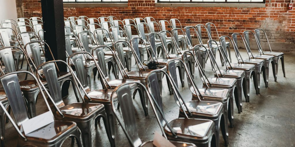 a room filled with lots of metal chairs